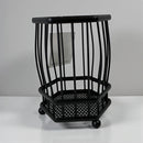 Black metal umbrella stand on a white surface with a gray background