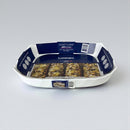 White baking dish with blue and white label on a gray background