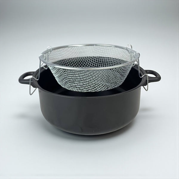 Black pot with a metal mesh strainer on a light gray background