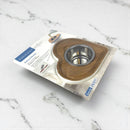 Wooden and metal pet bowl on packaging with visible branding on a marble surface