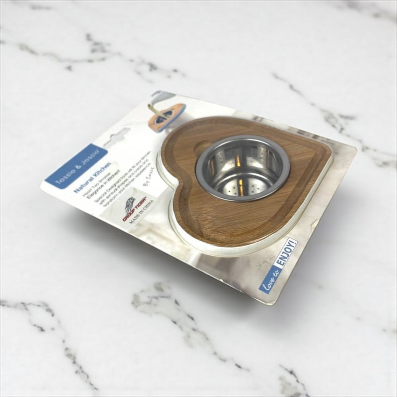 Wooden and metal pet bowl on packaging with visible branding on a marble surface