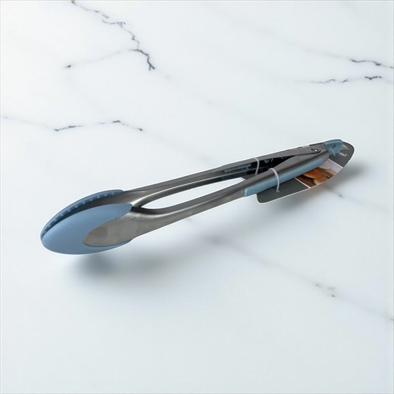 Metal tongs with blue silicone tips on a marble surface available at cupindy.com