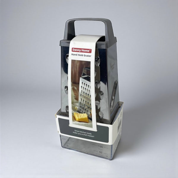 Handheld grater with packaging on a gray background available at cupindy.com