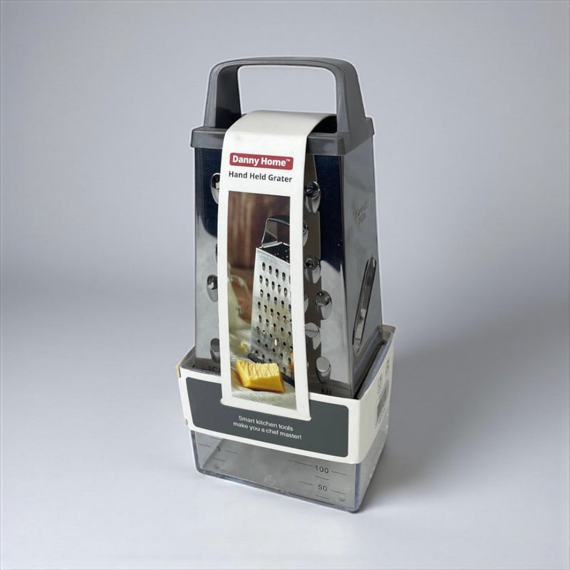 Handheld grater with packaging on a gray background available at cupindy.com