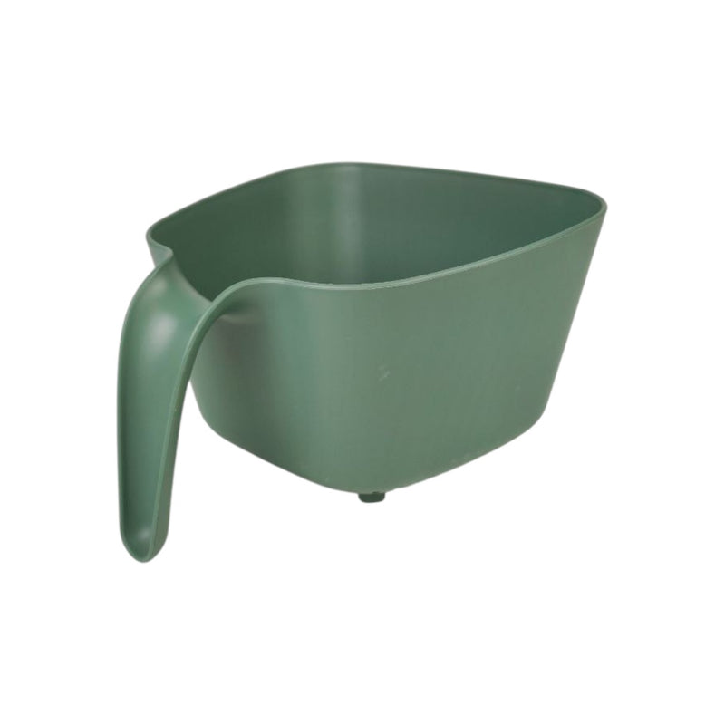 Green plastic scoop on a white background