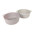 Two beige plastic colanders with handles on a white background