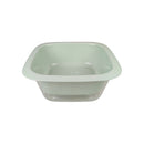 Light green plastic basin with a strainer on a white background