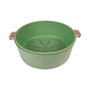 Green colander with handles on a white background