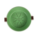 Green plastic strainer with brown handles on a white background