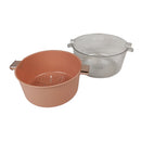 Two kitchen utensils, one terracotta-colored and one clear plastic, on a white background.