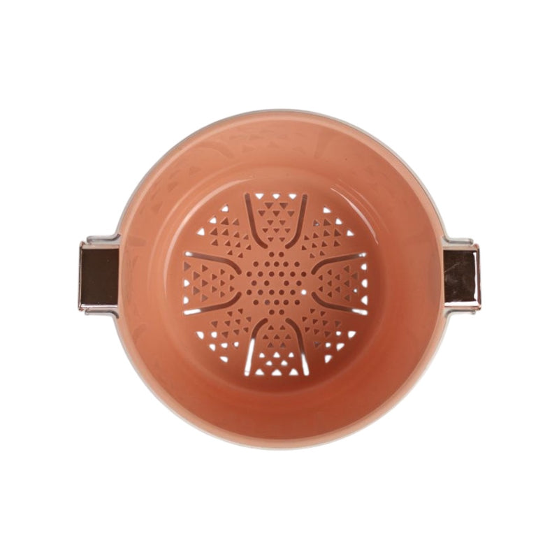 Ceramic tea infuser with decorative design on a white background