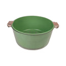 Green colander with metallic handles on a white background