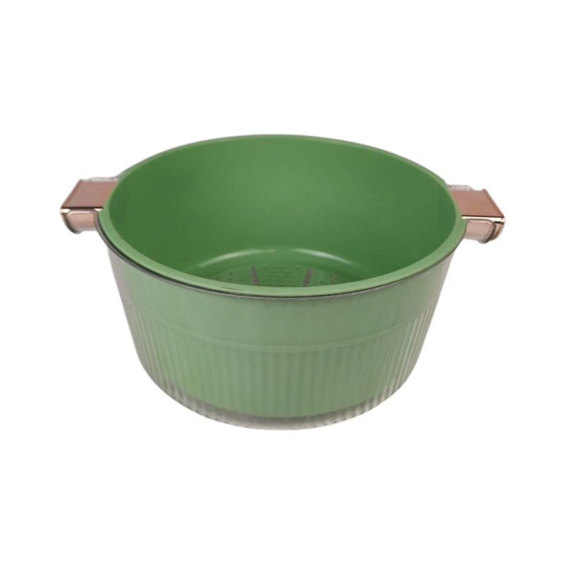Green colander with metallic handles on a white background