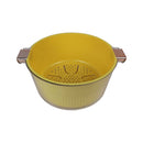 Yellow colander with metal handles on a white background