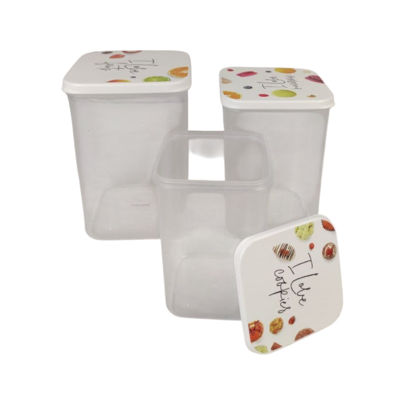 Set of three clear containers with decorative lids on a white background