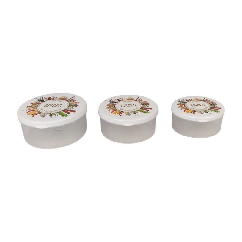 Three white spice containers with decorative lids on a white background