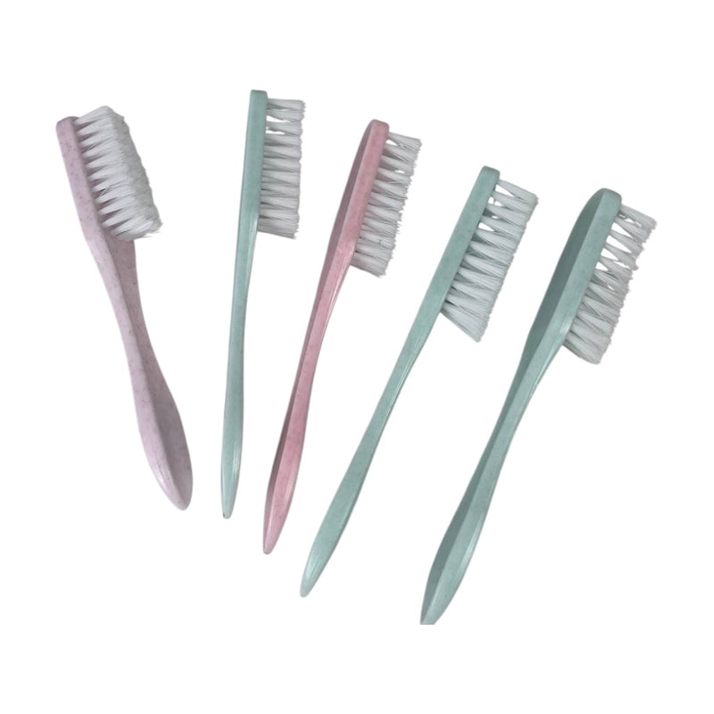 Set of five small toothbrushes with soft bristles on a white background