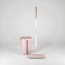 Pink mop and bucket set on a light gray background