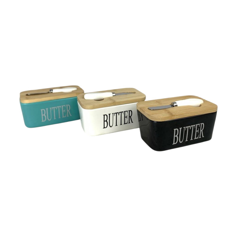 Three butter containers with wooden lids on a white background