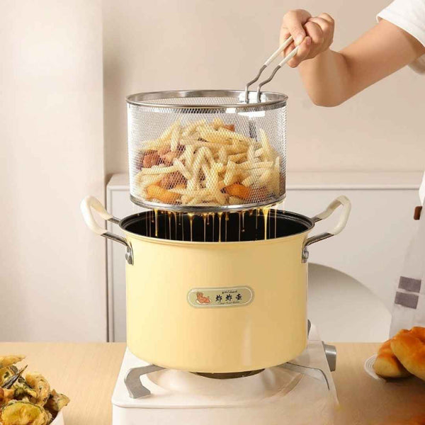 Yellow deep fryer with a strainer of fried food on a white background