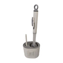 Gray toilet brush and holder set on a white background