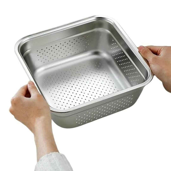 Stainless steel perforated pan held by a person on a white background available at cupindy.com