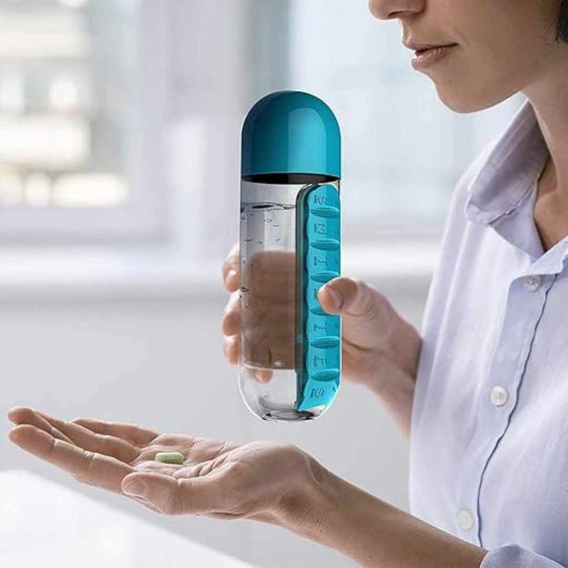 Person holding a blue pill organizer with a pill in front of them