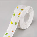 Roll of white ribbon with fruit patterns on a gray background