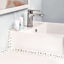 Bathroom sink with decorative border and toiletries