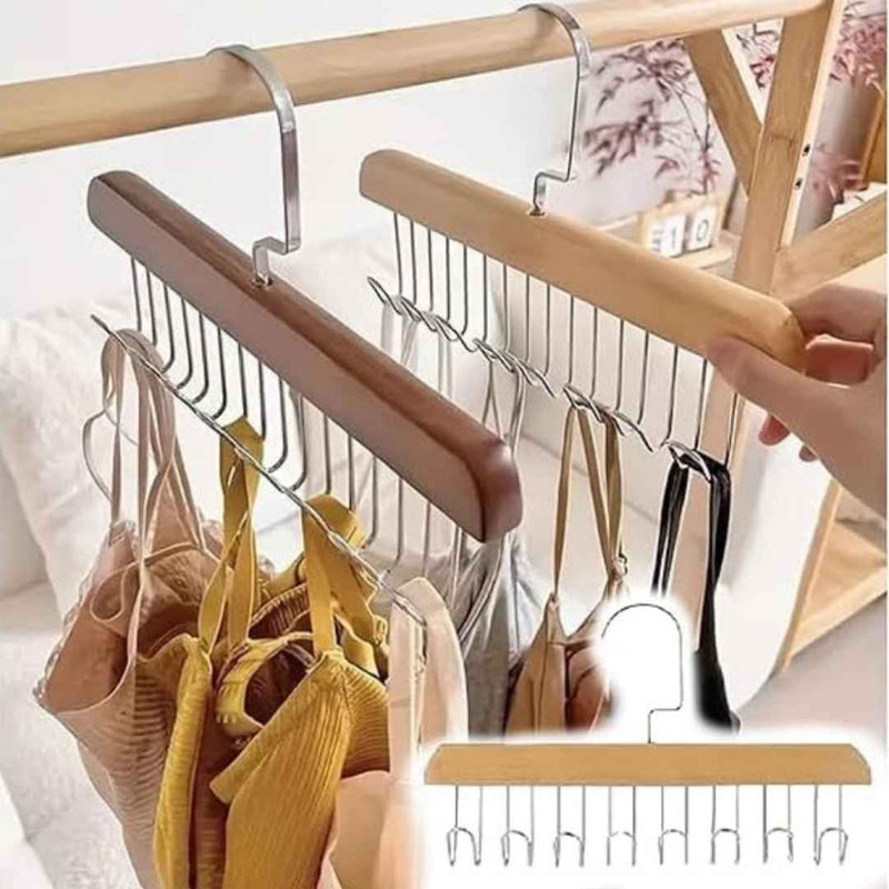 Clothing hanger with multiple hooks holding various items on a wooden rack.