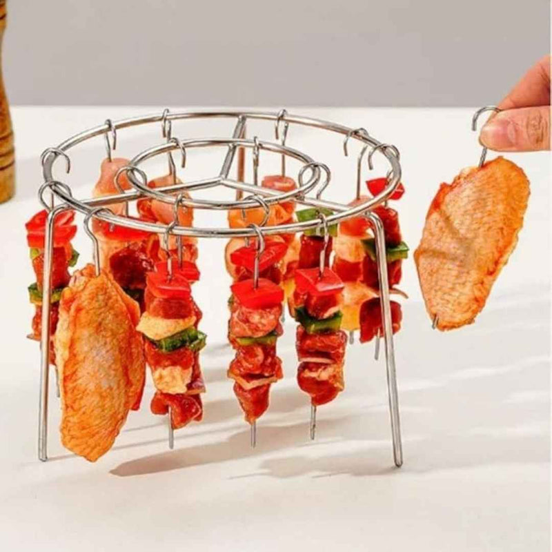 Metal skewer holder with skewered food on a white background