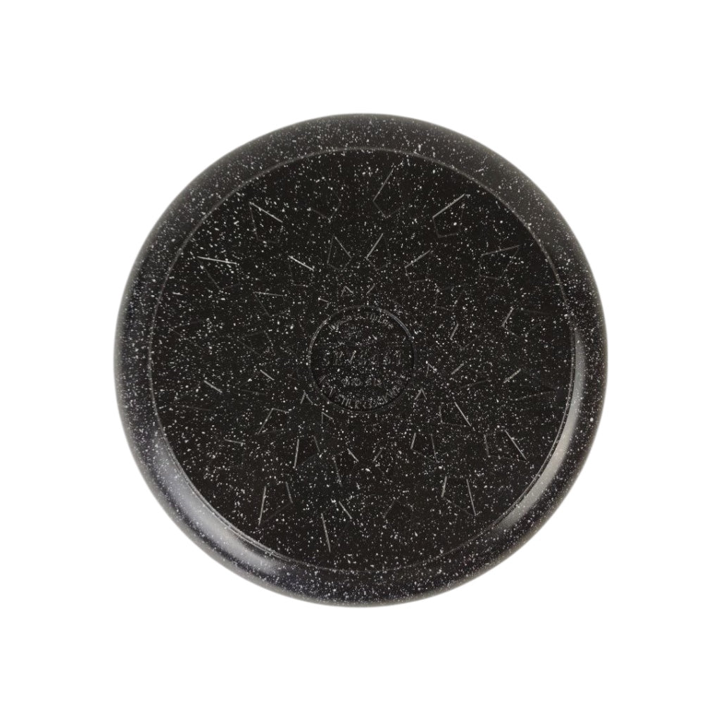 Black stone disc with textured surface on a white background