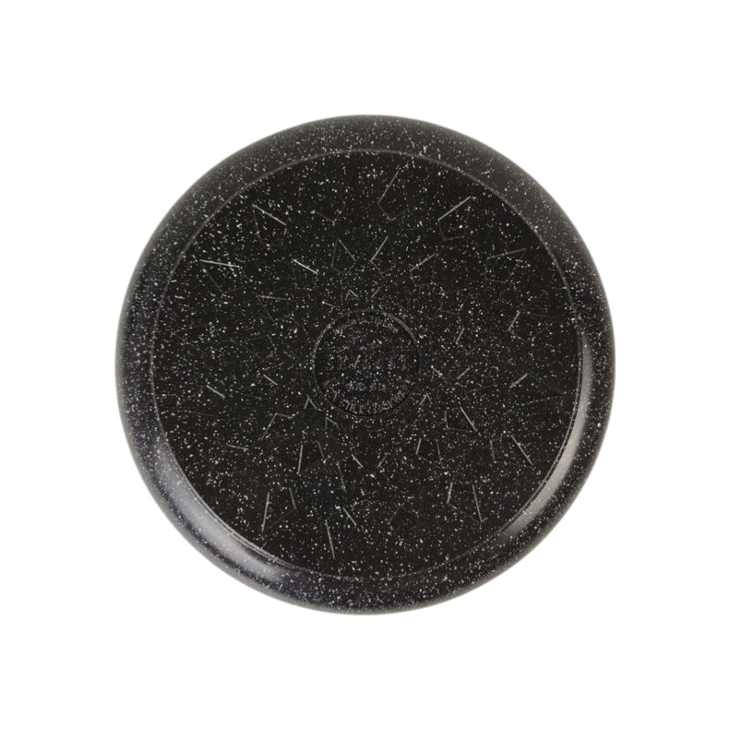 Black stone disc with textured surface on a white background