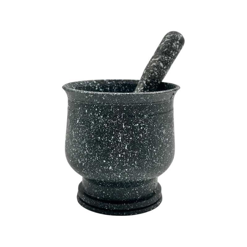 Black granite-style mortar and pestle set with white speckles, used for grinding herbs and spices in the kitchen