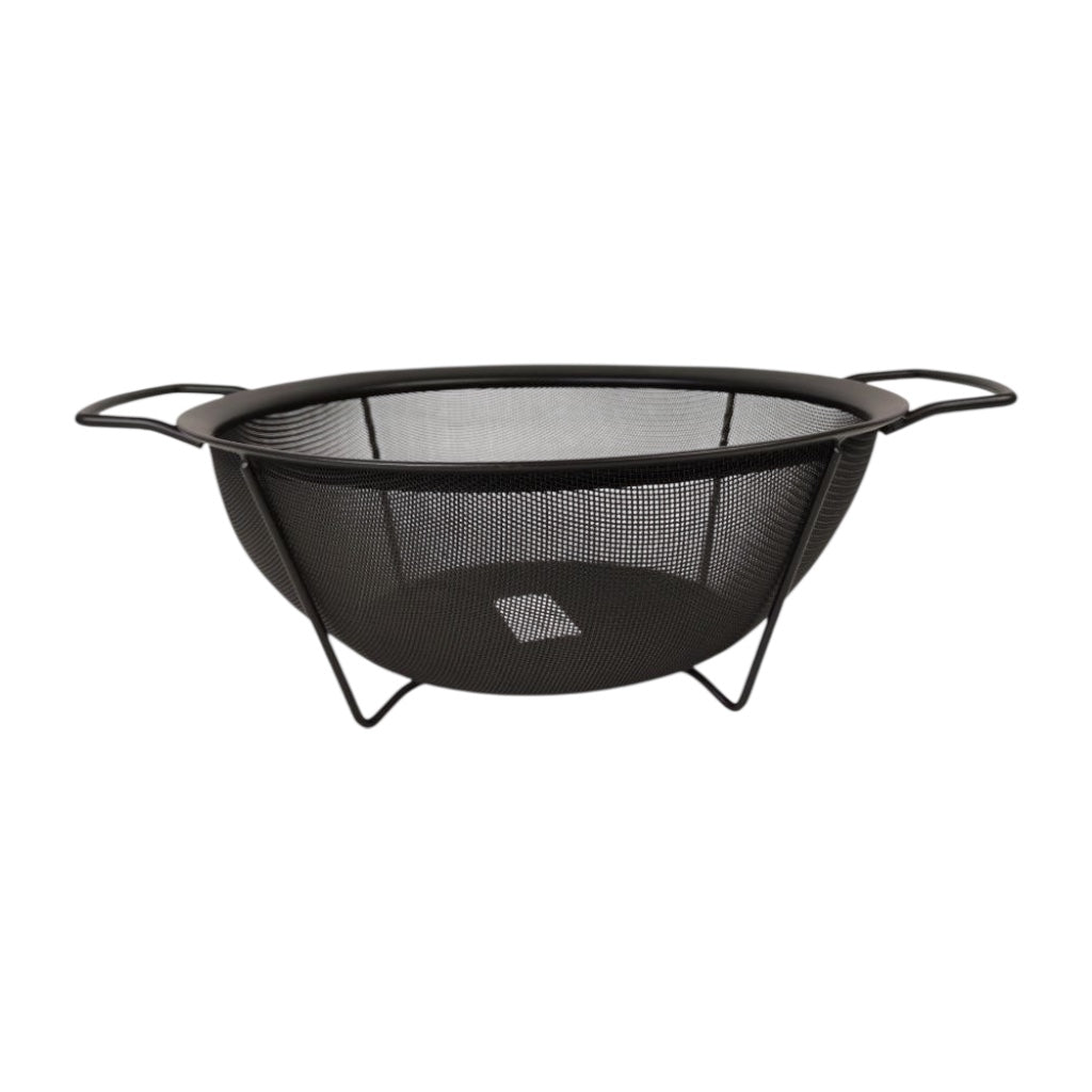 Black metal fire pit with mesh design on a white background