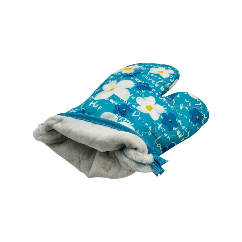 Close-up of blue floral quilted oven mitt showing thick white cotton lining, heat-resistant kitchen glove