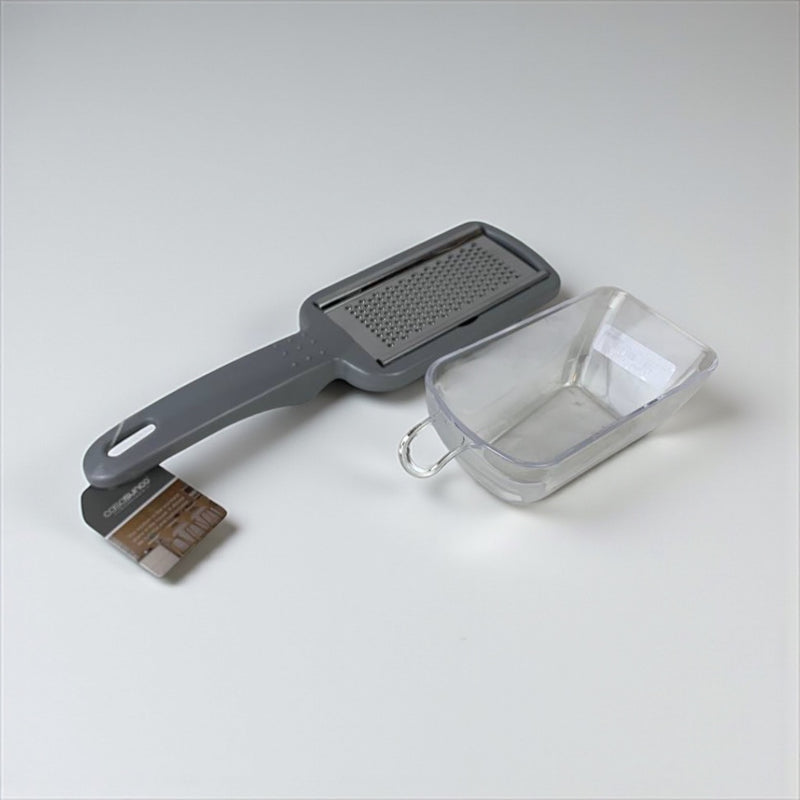 Kuhn Rikon grill brush and scrubber with a clear container on a white background