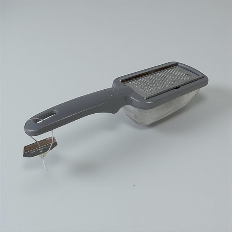 Handheld vegetable grater with a clear container on a light gray background