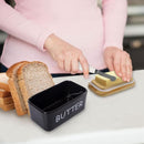 Butter dish with a knife and slices of bread on a table