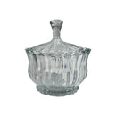 Clear glass candy dish with lid on a white background