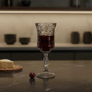 Decorative glass with red liquid on a kitchen counter