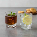Two glasses of iced beverages with lemon slices and mint leaves on a gray surface.