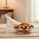 Glass bowl with mixed nuts and dried fruits on a wooden surface