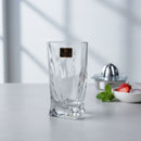 Clear glass tumbler on a kitchen counter with a blurred background