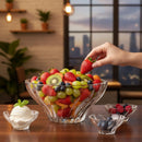 Fruit bowl with a hand picking a strawberry, cityscape in the background