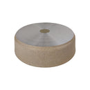 Round stone table with metallic top on a white background