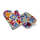 Colorful quilted kitchen oven mitt and pot holder set with multicolor floral and heart pattern on white background