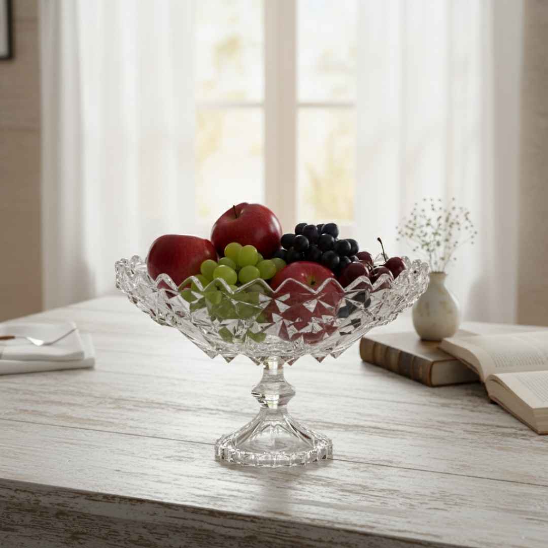Clear glass fruit bowl with fruits on a wooden table