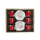 Set of red cups with gold rims and white teapots in a box on a white background