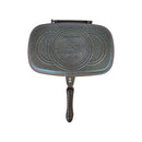 Double-sided grill pan with speckled surface on a white background